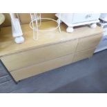 A MODERN LIGHT WOOD EFFECT LOW CHEST OF TWO LONG AND TWO SHORT DRAWERS