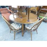 AN ERCOL OVAL DROP LEAF DINING TABLE, TOGETHER WITH A SET OF FOUR ERCOL STICK BACK CHAIRS (5)