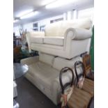 A PAIR OF MODERN TWO SEATER CREAM HIDE SETTEES