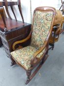 VICTORIAN MAHOGANY ROCKING CHAIR, HAVING PAD BACK AND SEAT AND SCROLL ARMS, ALL RAISED ON CABRIOLE