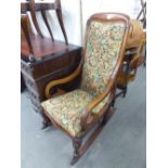 VICTORIAN MAHOGANY ROCKING CHAIR, HAVING PAD BACK AND SEAT AND SCROLL ARMS, ALL RAISED ON CABRIOLE