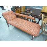 LATE VICTORIAN ANTIQUE CHAISE LONGUE, RAISED ON TURNED SUPPORTS, COVERED IN RED AND GILT FABRIC