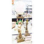 A MARBLE AND BRASS TABLE LAMP, STYLIZED BRASS STAND WITH TWO CHERUBS PERCHED ON A SHAPED MARBLE