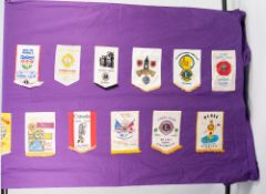 A LONG PURPLE FABRIC SHEET, applied with approx 40 Lions Club pennants