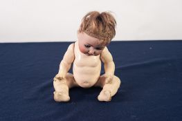 GERMAN EARLY TWENTIETH CENTURY BABY DOLL with socketed bisque head, blue sleeping eyes, open mouth