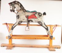 MID CHILD'S TRIANG MEDIUM SIZED CARVED AND PAINTED WOOD PLATFORM ROCKING HORSE, with leather tack