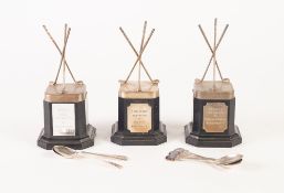 THREE MATCHING ELECTROPLATED 'HOLE IN ONE' GOLF TROPHIES, each with crossed clubs on an black