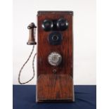 EARLY 20th CENTURY OAK CASE MURAL TELEPHONE, the front with two metal bells over a fixed black