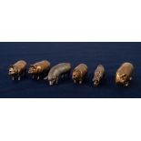 TWO BRASS VESTA BOXES, each modelled as a pig with the head as a hinged lid; a brass pig TAPE