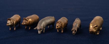 TWO BRASS VESTA BOXES, each modelled as a pig with the head as a hinged lid; a brass pig TAPE