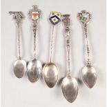 FOUR SILVER COLOURED METAL AND ENAMELLED SOUVENIR TEASPOONS, for 'Dinard' 'Montreaux' and another (