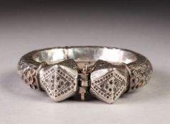 A LARGE SILVER COLOURED METAL TORQUE BANGLE, having repousse and etched decoration throughout,