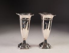 GEORGE V PAIR OF WEIGHTED SILVER TRUMPET VASES, each of square, moulded form with flared rim and