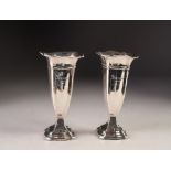 GEORGE V PAIR OF WEIGHTED SILVER TRUMPET VASES, each of square, moulded form with flared rim and