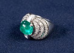 PLATINUM, EMERALD AND DIAMOND COCKTAIL RING, WITH A CABOCHON OVAL NATURAL EMERALD OF VERY STRONG