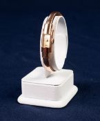 LADY'S BAUME & MERCIER, GENEVE, 18ct GOLD SPRUNG BANGLE WATCH with mechanical movement, tiny