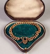 AN EDWARDIAN 9ct GOLD CURB LINK BRACELET, with padlock clasp, Birmingham 1909, in morocco heart