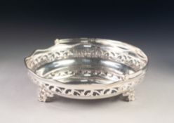 GEORGE V SILVER SWING HANDLED CAKE BASKET, of circular, dished form with scroll pierced border and