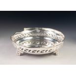 GEORGE V SILVER SWING HANDLED CAKE BASKET, of circular, dished form with scroll pierced border and
