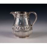 GOOD QUALITY VICTORIAN SILVER CREAM JUG, the pear shaped body demi-gadrooned and embossed with