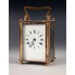 A MID TWENTIETH CENTURY BRASS CASED CARRIAGE CLOCK of typical form with oblong white dial, black