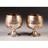 PAIR OF SILVER BRANDY BALLOONS on short waisted stems and stepped circular bases, gilt interiors,