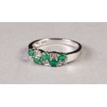10k WHITE GOLD, DIAMOND AND EMERALD RING, with a two row over and under setting of five tiny