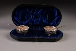 PAIR OF VICTORIAN SILVER CIRCULAR SALT RECEIVERS, spirally fluted with crimped edge, on three ball