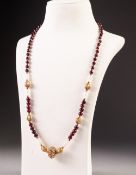 AN EASTERN BEAD NECKLACE, with back section of alternate small garnet beads with small gilt metal