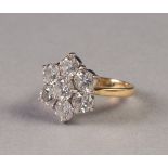 18ct GOLD AND DIAMOND DAISY CLUSTER RING, set with seven round brilliant cut diamonds, the centre