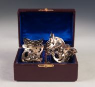 CASED PAIR OF LATE VICTORIAN PIERCED SILVER NAPKIN RINGS, of waisted form, London 1898, 2oz, in