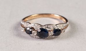 9ct GOLD, SAPPHIRE AND TINY DIAMOND RING, the open work setting having a row of three graduated oval