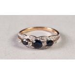 9ct GOLD, SAPPHIRE AND TINY DIAMOND RING, the open work setting having a row of three graduated oval