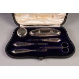 EDWARDIAN SILVER MANICURE SET OF SIX PIECES, in shaped and fitted rococo case comprising a nail
