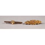 VICTORIAN 9ct GOLD FANCY WING SHAPED BROOCH, the raised lozenge shaped centre set with a tiny ruby