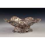 LATE VICTORIAN PIERCED SILVER BON BON DISH, of shaped oval form with embossed scroll centre and