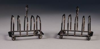 A PAIR OF 1920's SMALL FOUR DIVISION SILVER TOAST RACKS, of angular form with raised handles and
