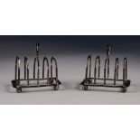 A PAIR OF 1920's SMALL FOUR DIVISION SILVER TOAST RACKS, of angular form with raised handles and