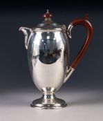 PRE-WAR SILVER COFFEE POT of oviform with composition handle and knop, rising from a stem foot,