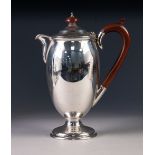 PRE-WAR SILVER COFFEE POT of oviform with composition handle and knop, rising from a stem foot,