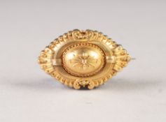 LATE VICTORIAN GOLD COLOURED METAL OVAL FORM LOCKET BROOCH, fan pattern ends, interlinked 'C'