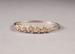 SILVER HINGED OPENING NARROW BANGLE, the top with seven pink enamelled flower heads, each set with a