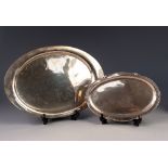 TWO FOREIGN SILVER COLOURED METAL OVAL SERVING DISHES, comprising: a plain example, with retailers