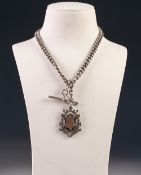 EDWARDIAN SILVER AND GOLD SHIELD MEDALLION PENDANT on a silver curb pattern double ALBERT, with