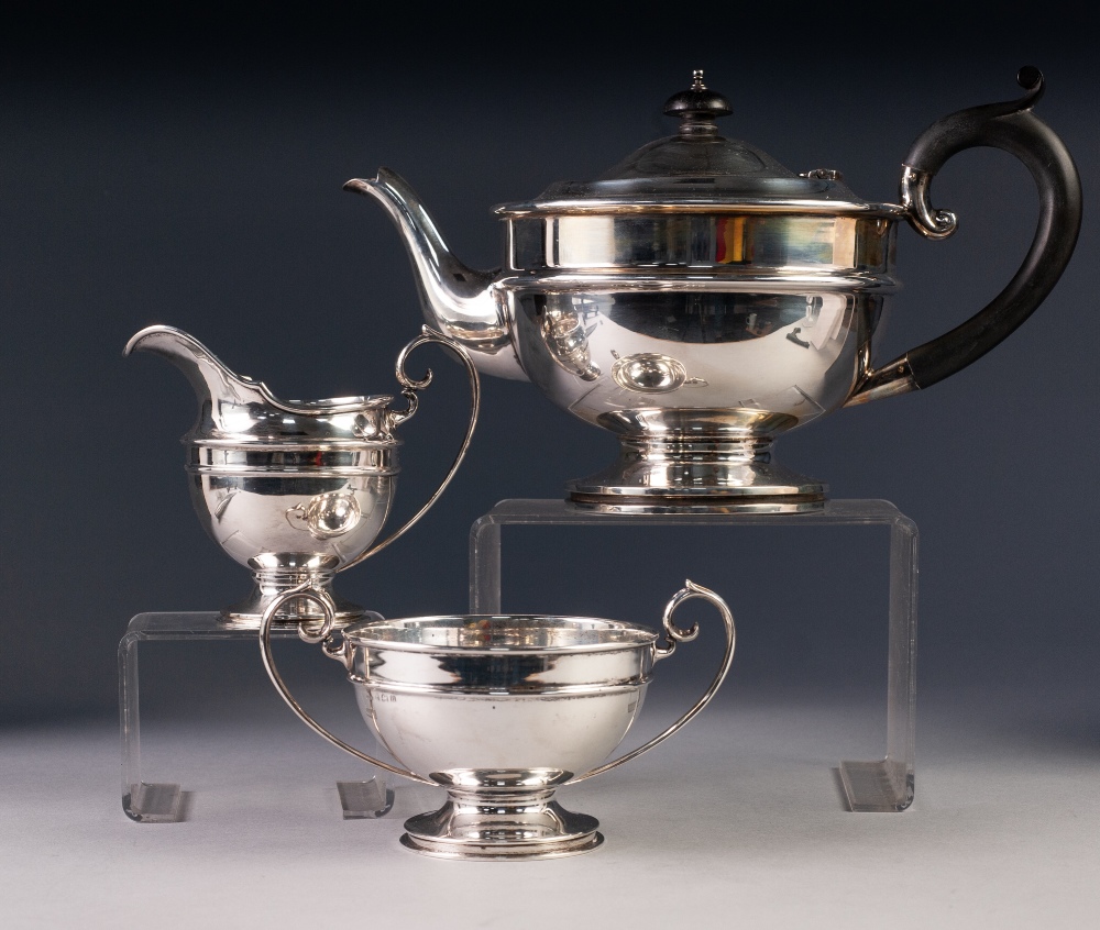 PRE-WAR THREE PIECE SILVER TEA SERVICE OF CIRCULAR PEDESTAL FORM, the teapot with blackwood handle