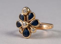 18ct GOLD FLORAL PATTERN DRESS RING, collet set with five petal shaped sapphires and four tiny