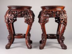 PAIR OF 20th CENTURY CHINESE CARVED WOODEN JARDINIERE STANDS with circular marble inset tops,