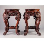 PAIR OF 20th CENTURY CHINESE CARVED WOODEN JARDINIERE STANDS with circular marble inset tops,