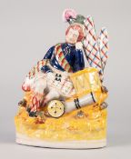 STAFFORDSHIRE POTTERY FIGURE OF A HIGHLAND SOLDIER, modelled seated againgst a drum, on a floral