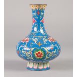 A CHINESE QING DYNASTY CANTON ENAMEL VASE of compressed baluster form rising from a spreading stem